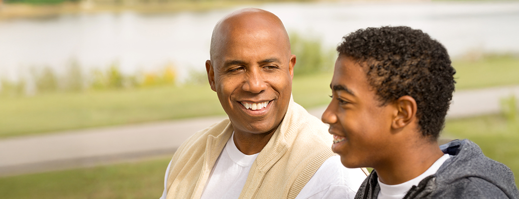 Image of middle-aged man talking to his teenaged son